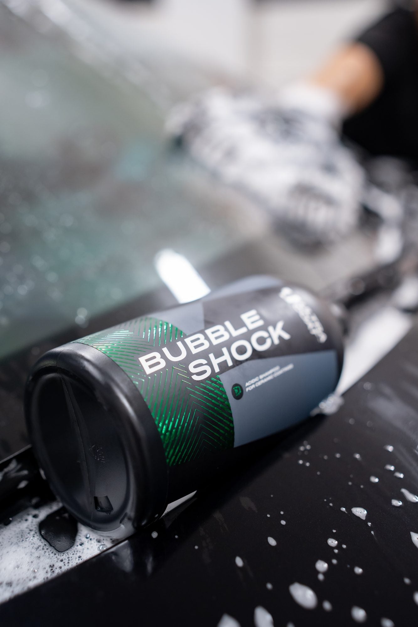 Ultracoat Bubble Shock bottle resting on a wet, foamed vehicle surface