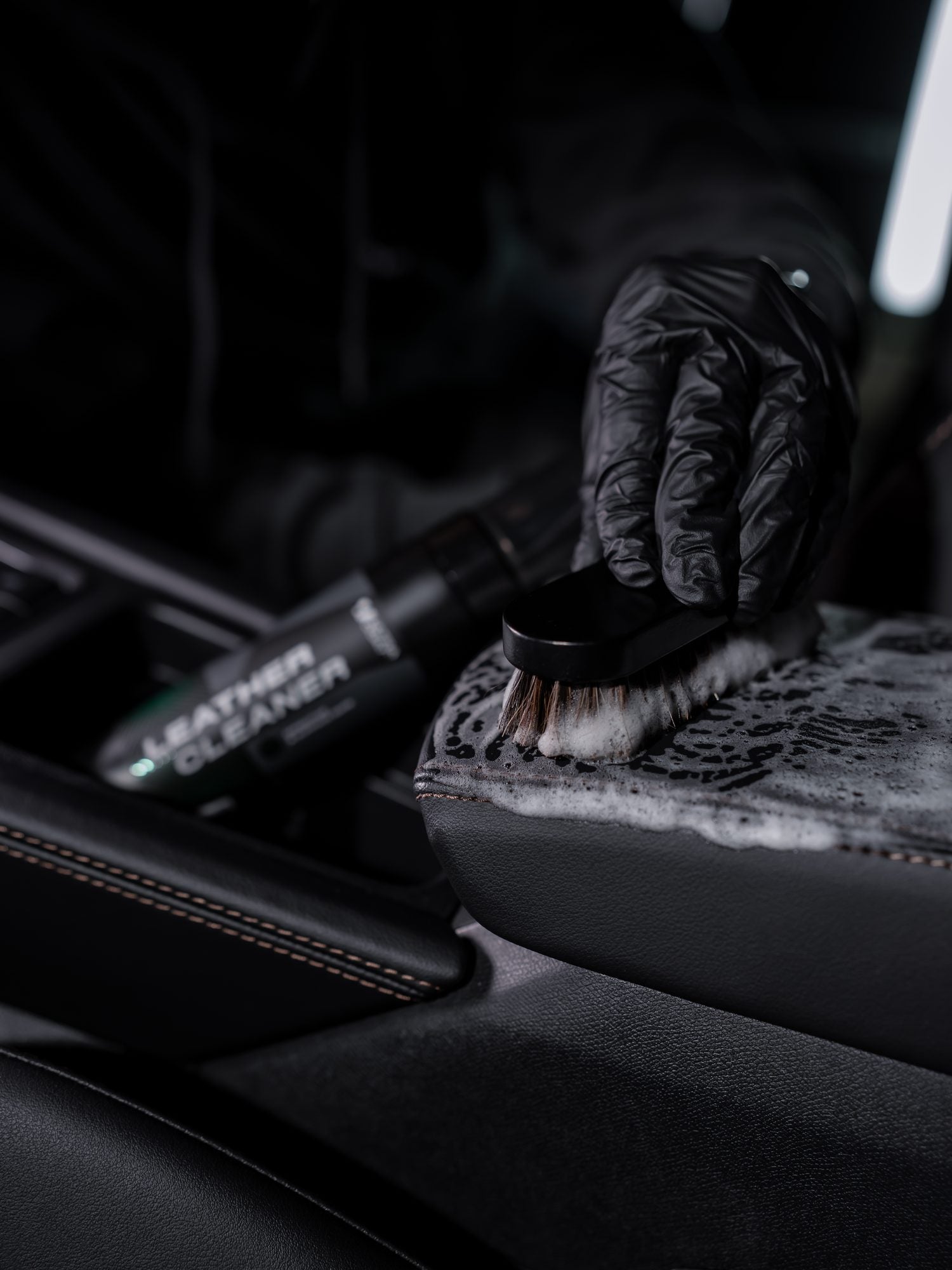 Ultracoat Leather Cleaner worked into leather upholstery with a detailing brush