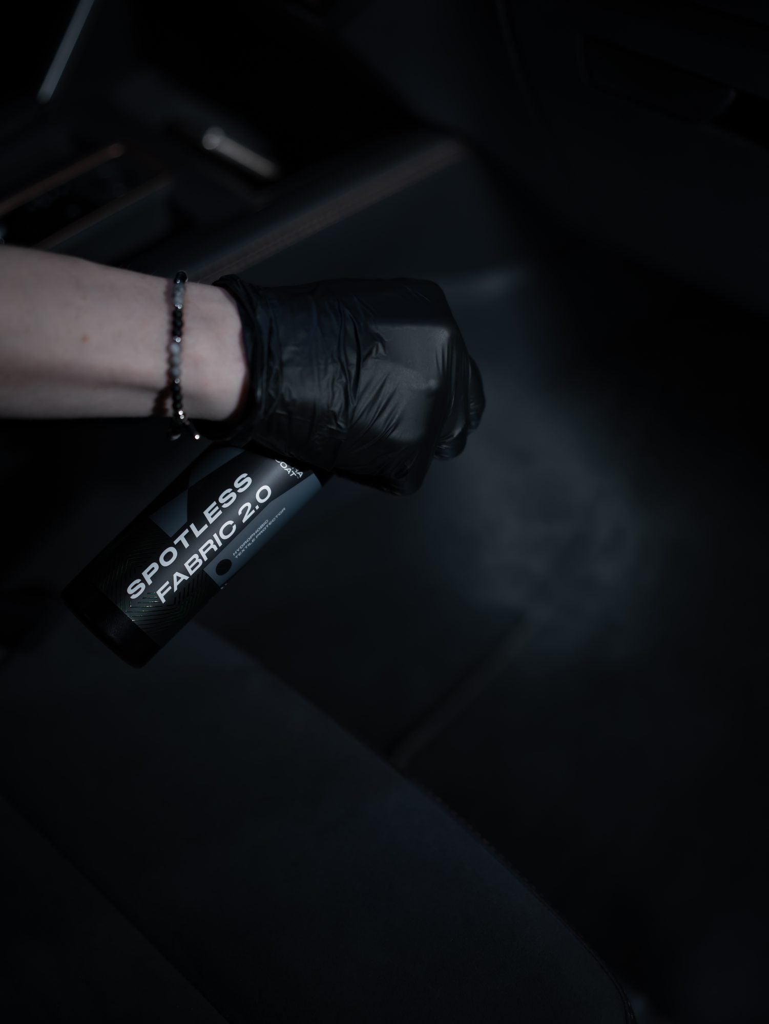 Ultracoat Spotless Fabric 2.0 applied to a dark textile interior surface