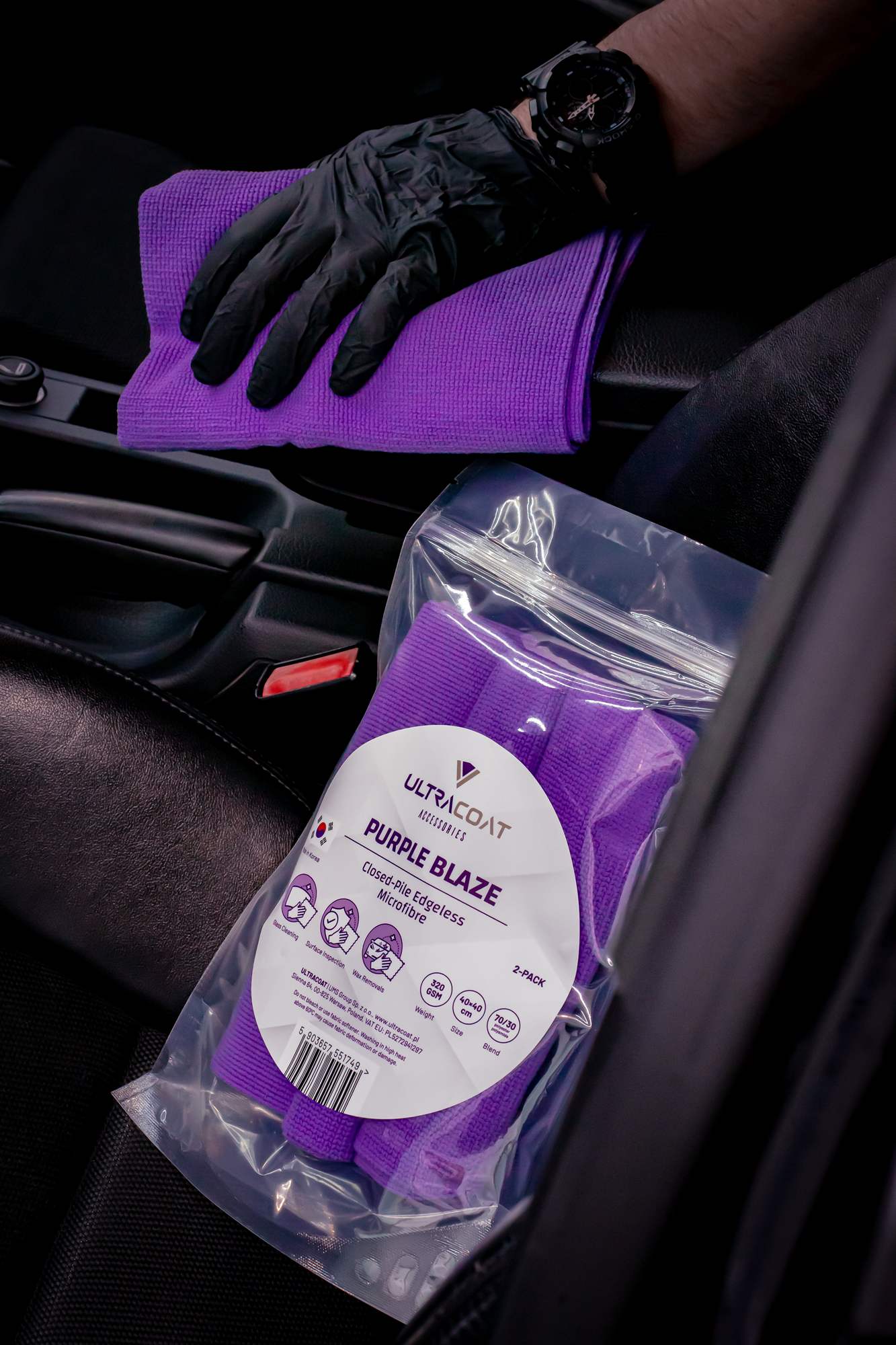 Ultracoat Purple Blaze microfibre towels packaged alongside a folded towel in a vehicle interior